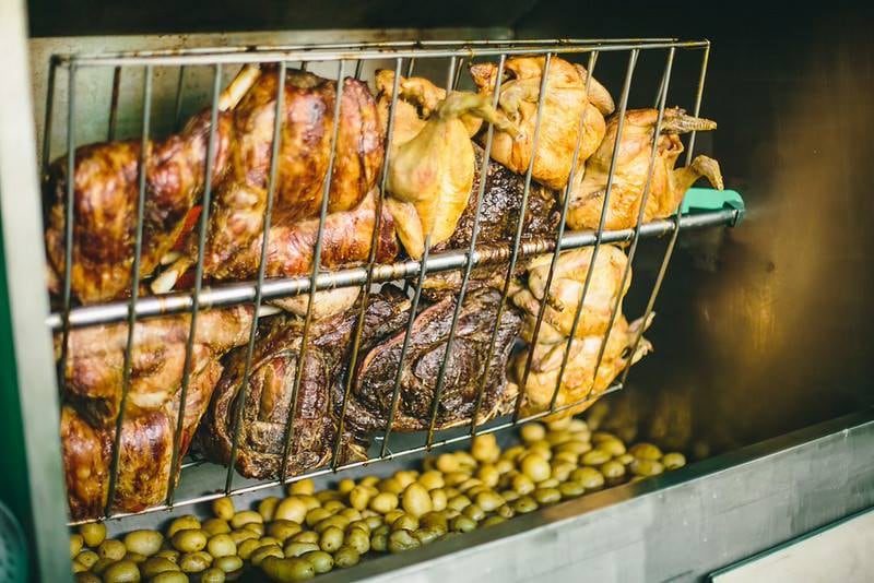 A selection of roast meats and whole chickens on a Challas spit